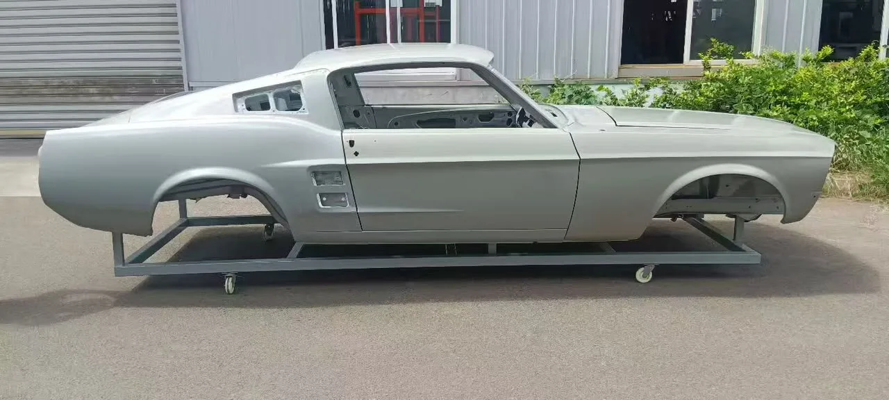 Unpainted 1967 Fastback body shell on a steel dolly, side profile